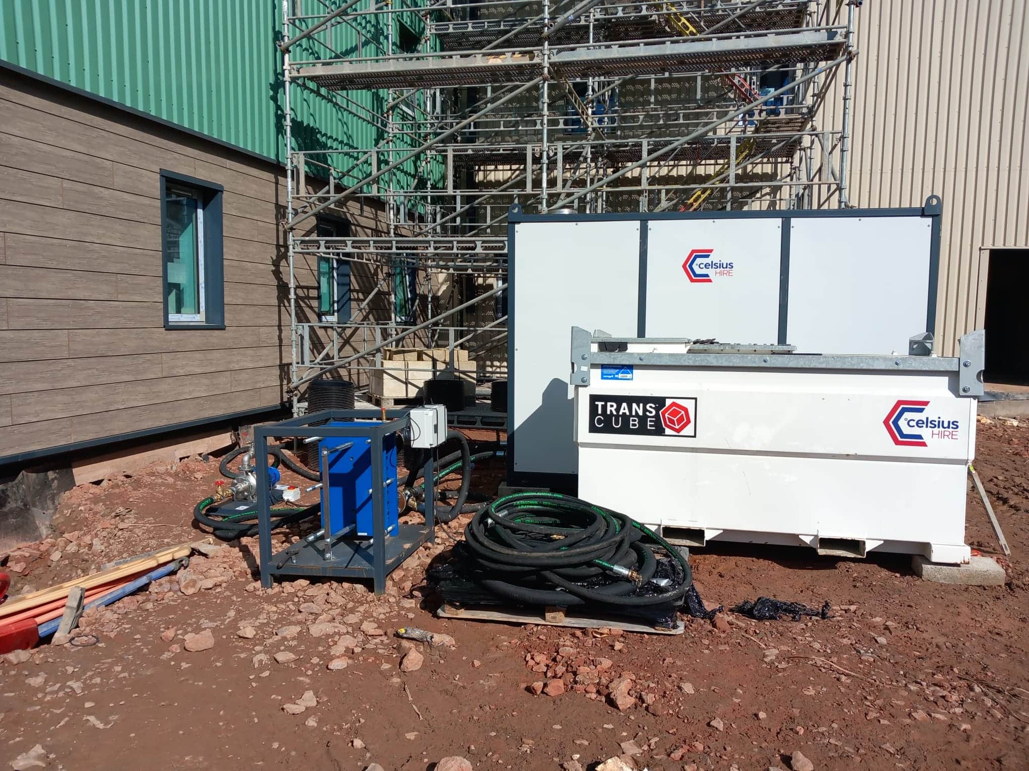Boiler and fuel tank on a hospital construction site with pumps and pipes in shot, scaffolding in the background. This product includes equipment damage waiver