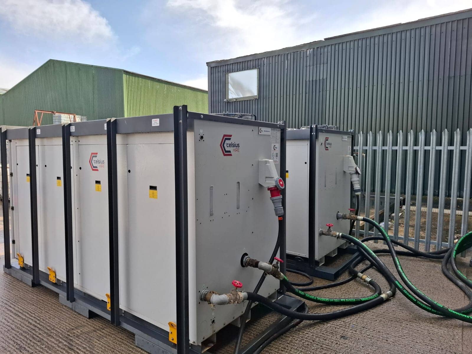 Temporary cold storage cooling chillers located outside the building with the ancillaries connected.