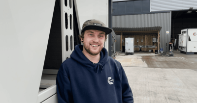engineer at Celsius Hire wearing a cap standing outside the office
